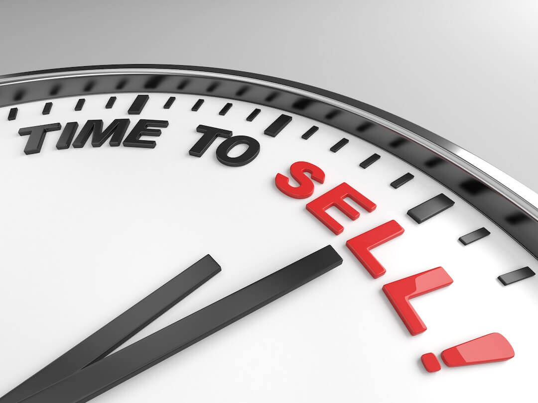 Clock with words time to sell on its face