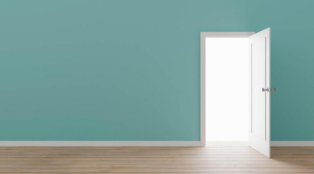 open white door in a painted aqua wall.