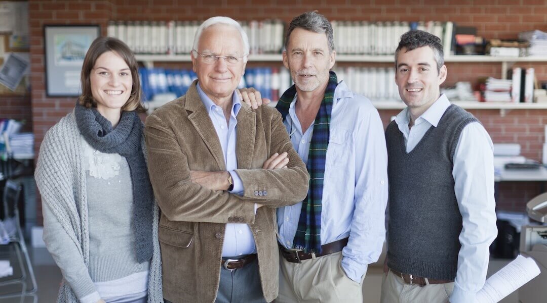 generations of a family-owned business stand inside the business office